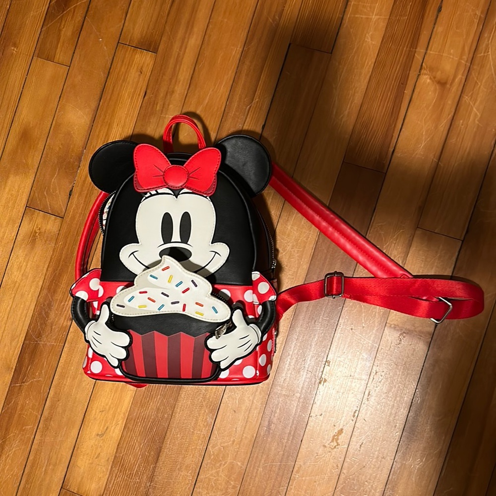 Loungefly mini backpack of Minnie Mouse with cupcake . Used one time .